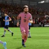 Lionel Messi in a pink Inter Miami kit running away after scoring.